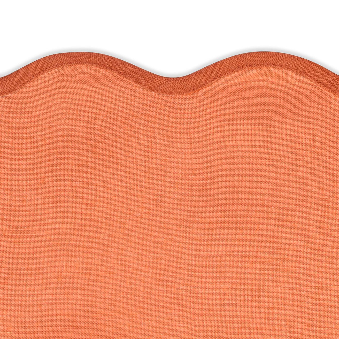Close-up of orange fabric with a visible weave and scalloped edge—ideal for the Matouk Scallop Edge | Napkin Set to elevate your tablescape.