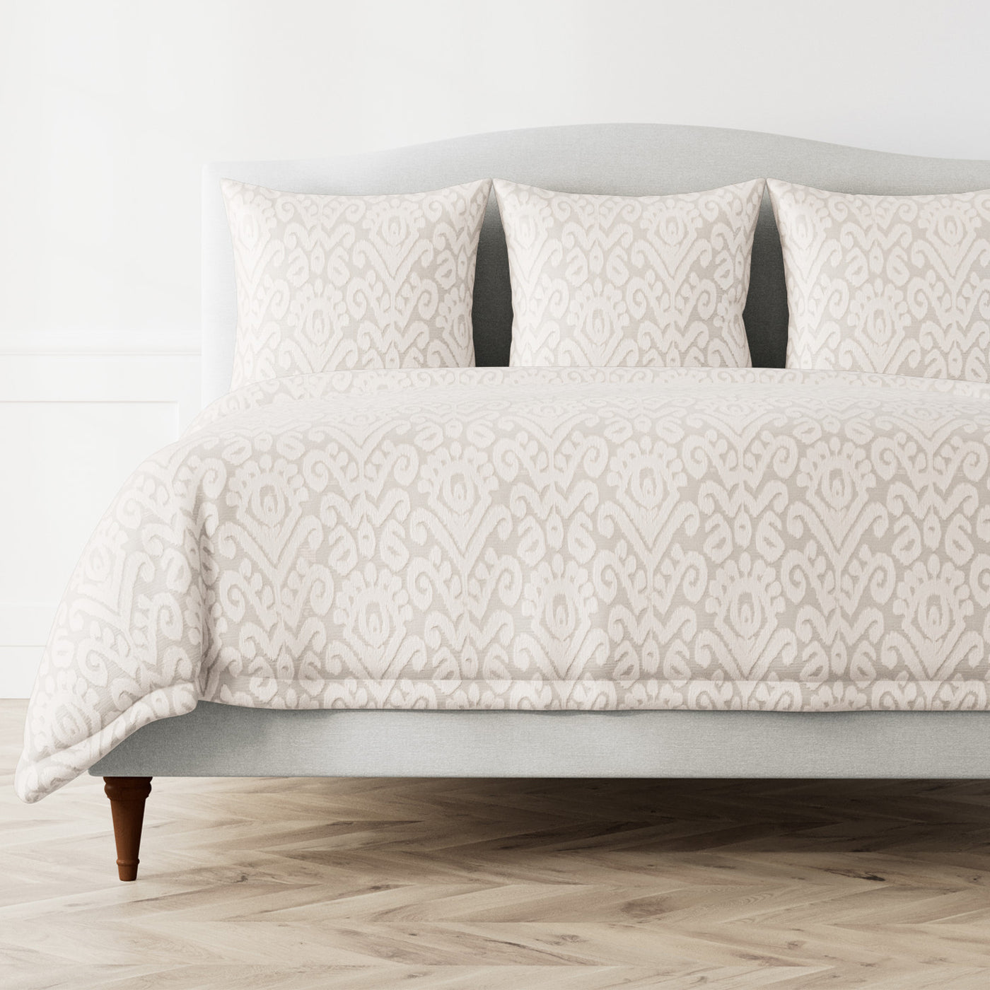 Ann Gish Scepter duvet cover in ivory with tone-on-tone damask ikat pattern on styled bed.