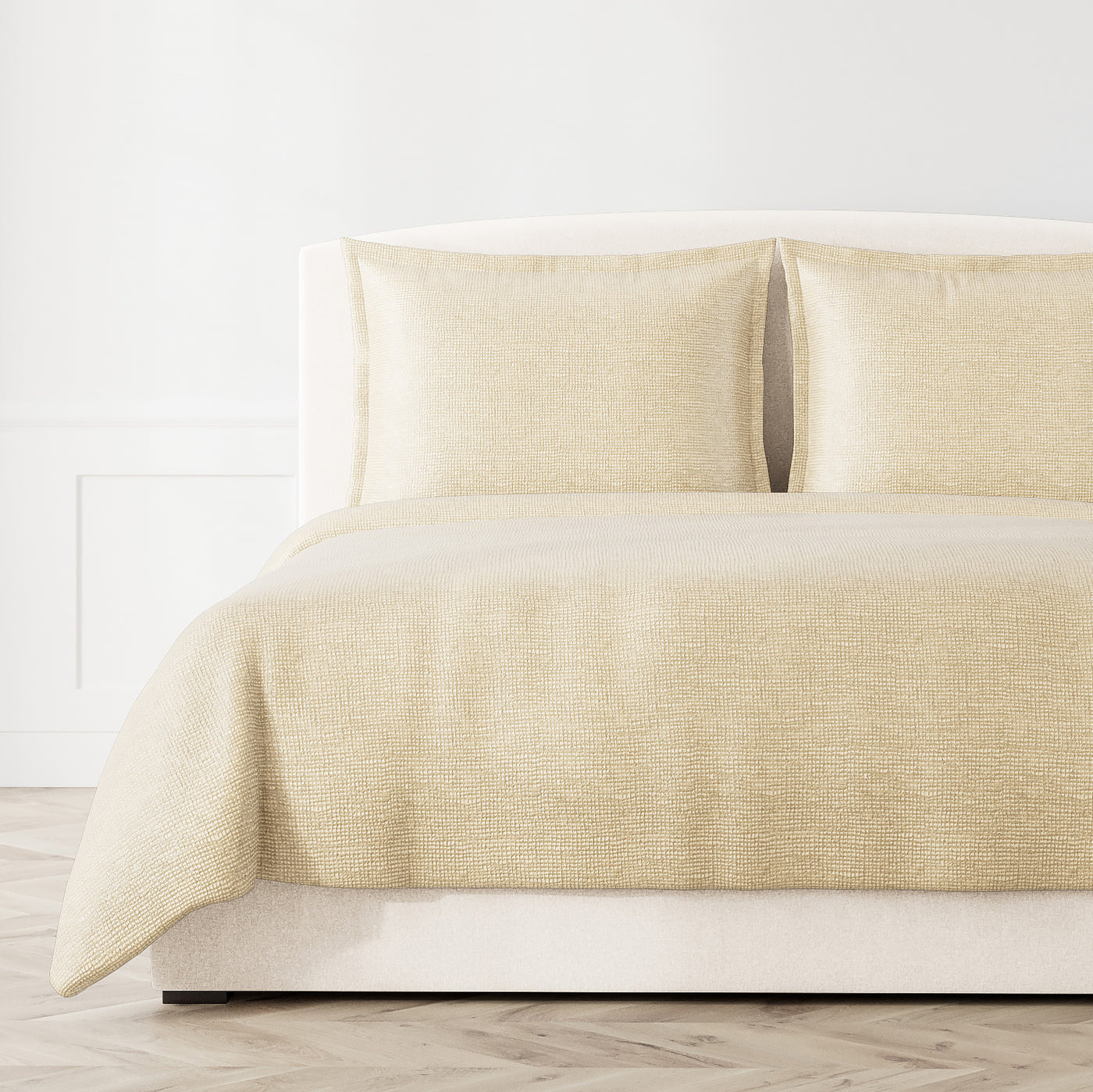 Ann Gish Screen coverlet in champagne, styled on a bed with matching shams.