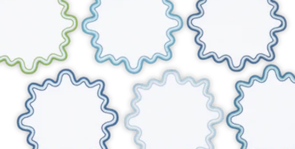 The Wave Cocktail Napkin Set by Matouk features six wavy-edged, blank circular napkins with blue and green two-tone borders, arranged in two rows on a white background.