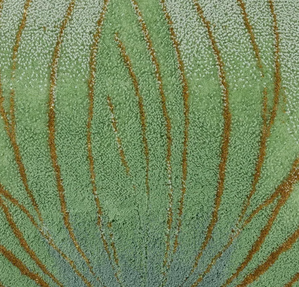 Close-up of sage green tufted lotus pattern with amber chenille detailing.