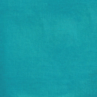 Close-up of Sferra Festival tablecloth in teal, showing linen-cotton texture.