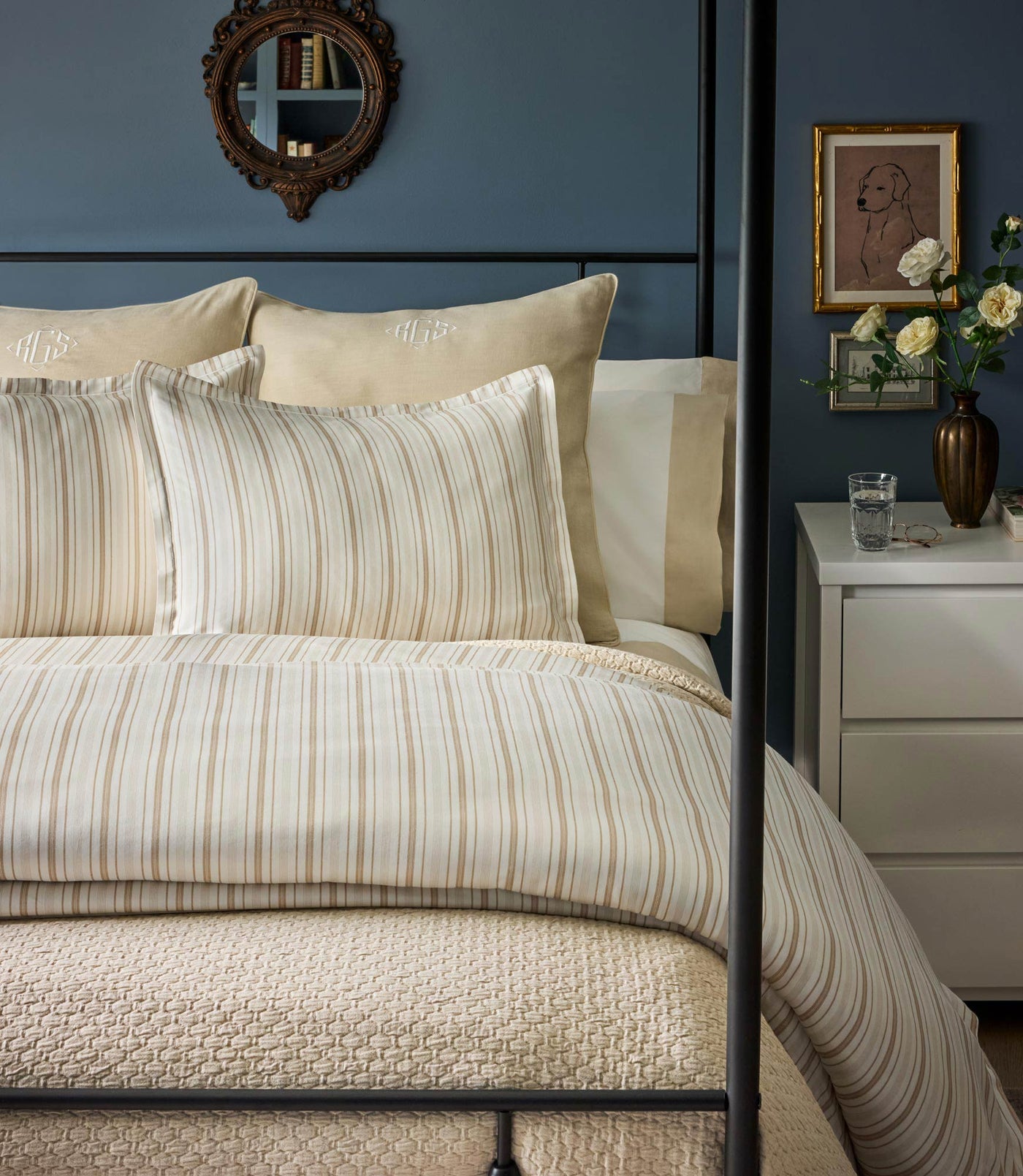 Peacock Alley Shelby duvet cover in champagne ticking stripes styled on a dark iron bed.