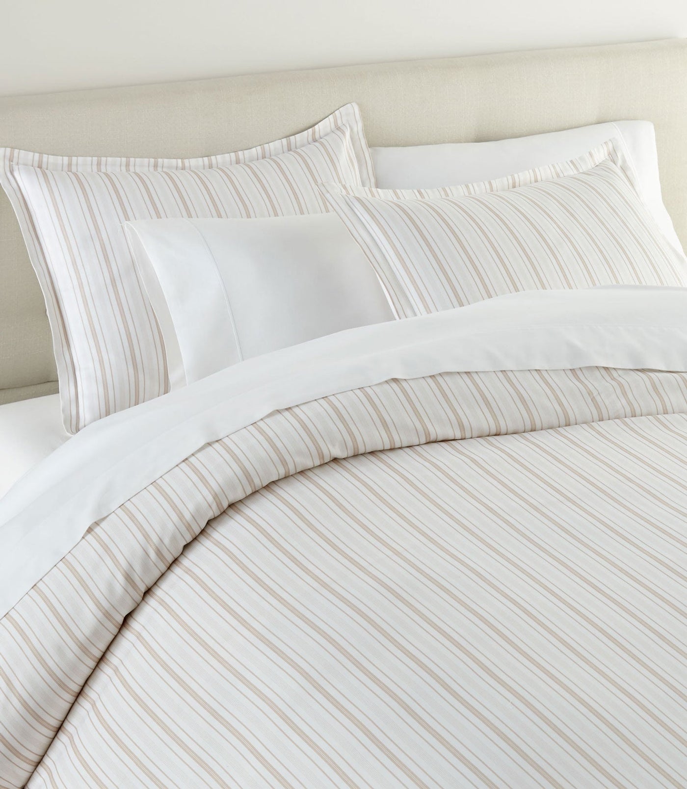 Close-up of Peacock Alley Shelby duvet cover showing tonal sand stripe pattern on ivory cotton.