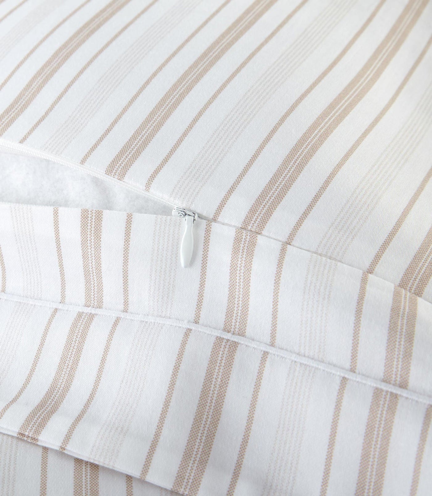 Close-up of Peacock Alley Shelby duvet cover zipper closure with sand stripe cotton fabric.