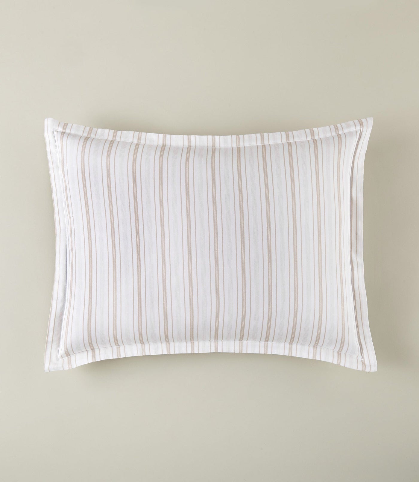 Close-up of Shelby pillow sham with sand and white vertical stripes and flange border.