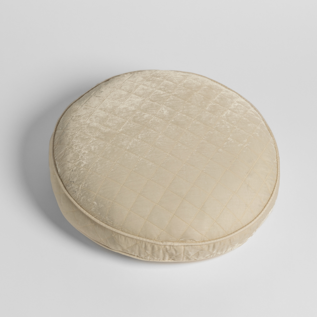 Bella Notte Silk Velvet Quilted round throw pillow in Crema, quilted diamond pattern.