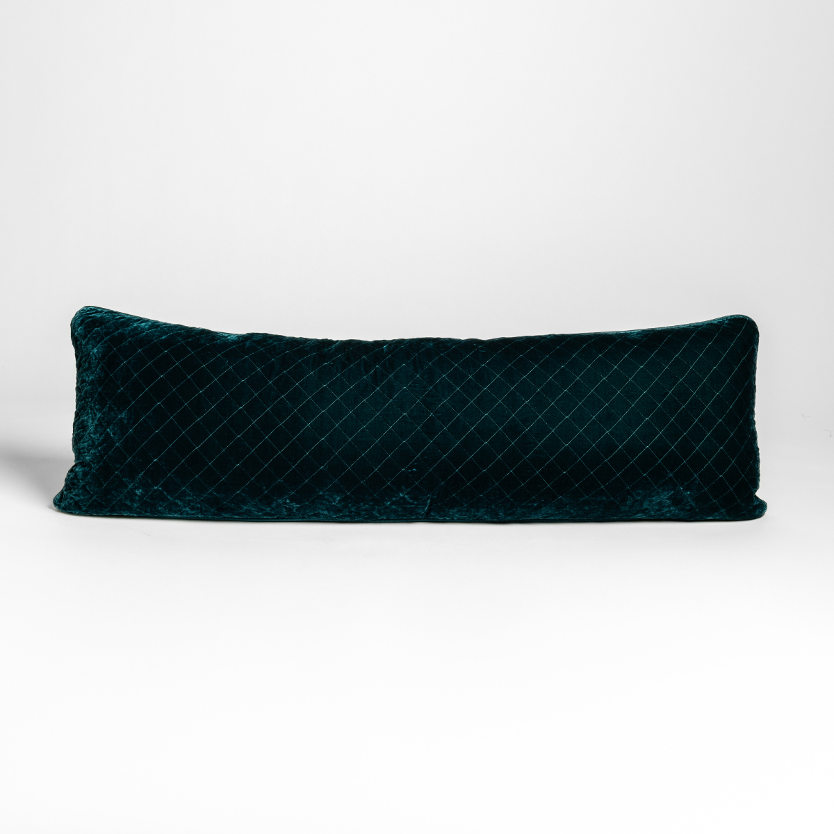Cenote quilted silk velvet lumbar pillow, diamond-stitched surface detail, long rectangular shape.