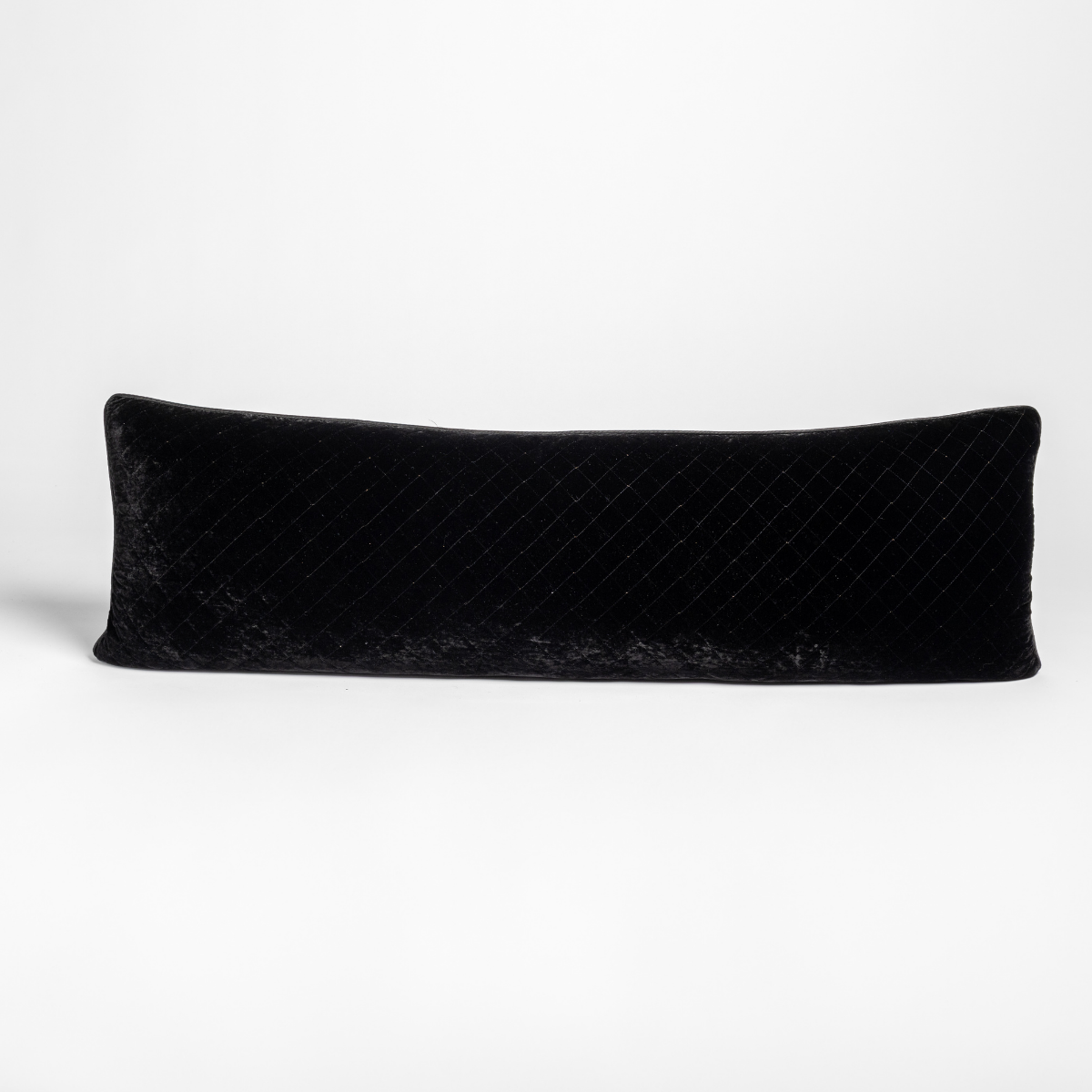Bella Notte Silk Velvet quilted lumbar pillow in Corvino, diagonal quilting detail visible.