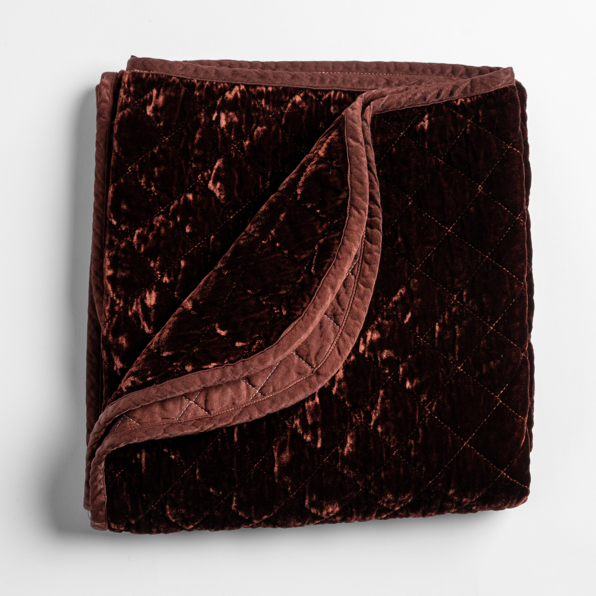Folded Bella Notte Silk Velvet Quilted Blanket in Autumn, showing crushed velvet texture and diamond-stitched border.