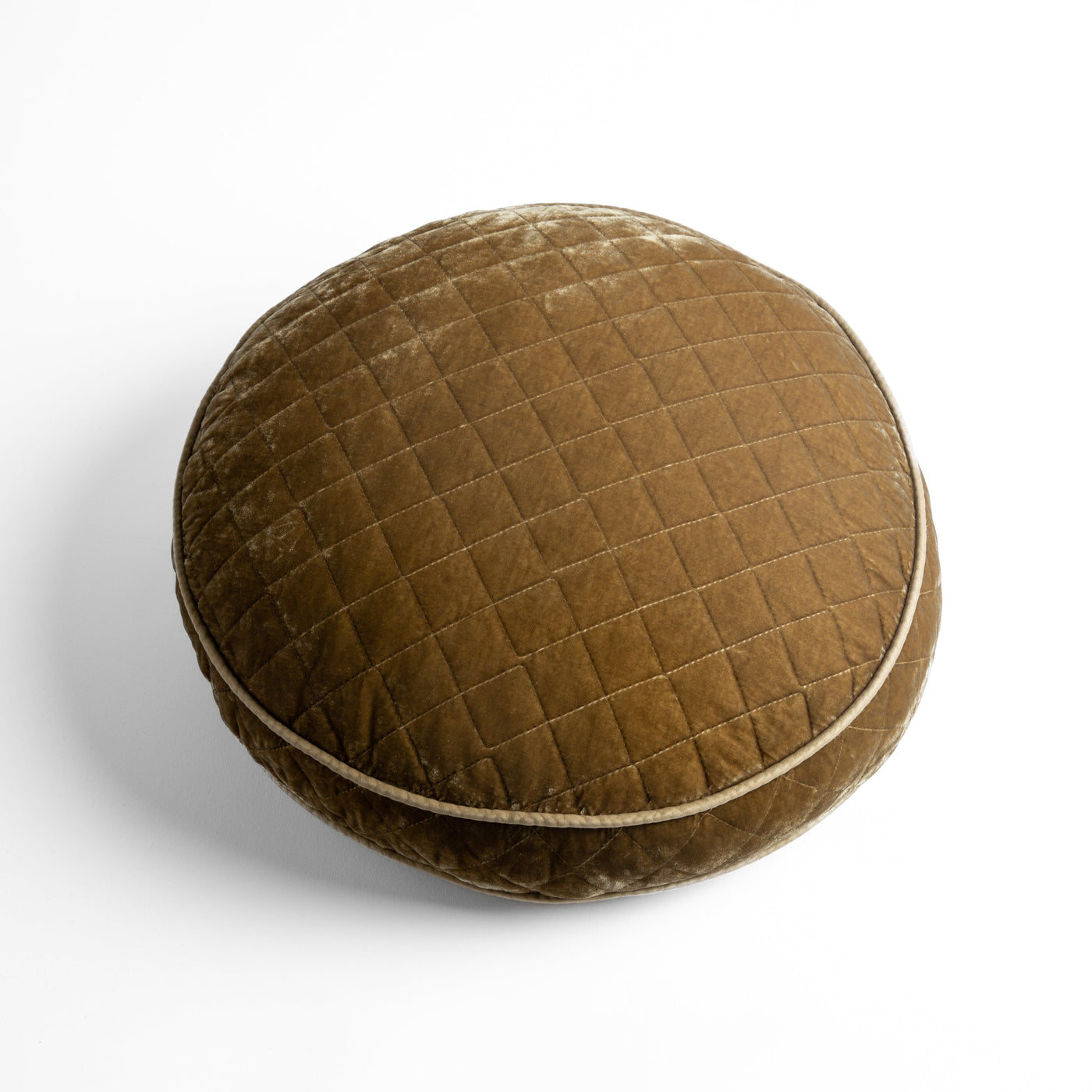 Round Honeycomb silk velvet quilted throw pillow with ivory piped edge, overhead view.