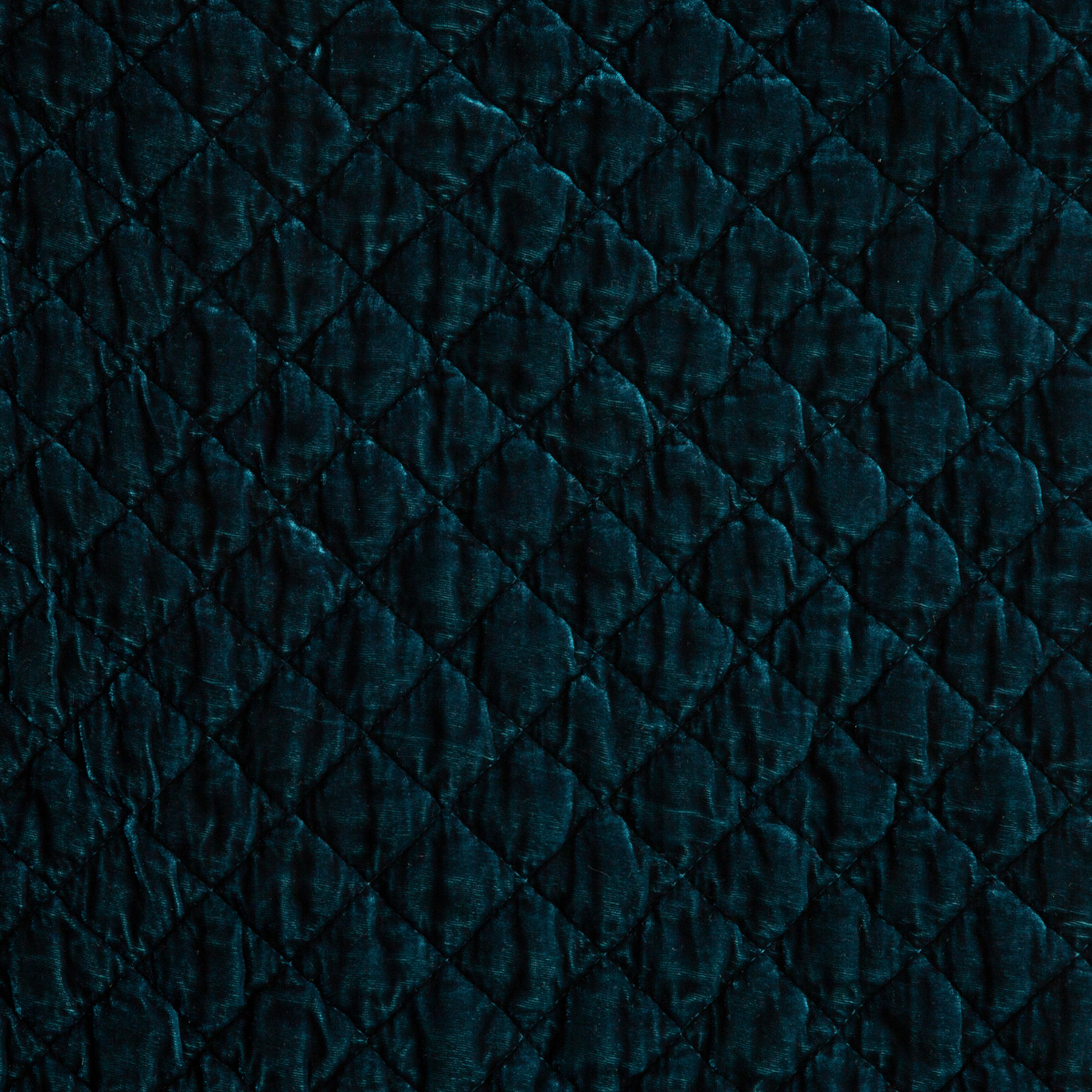 Close-up of Bella Notte Silk Velvet Quilted Sham in Cenote, showing diamond quilt stitching on rich velvet.