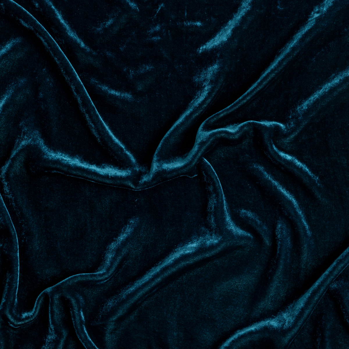 Close-up of Cenote velvet fabric with deep teal sheen and soft draped folds.
