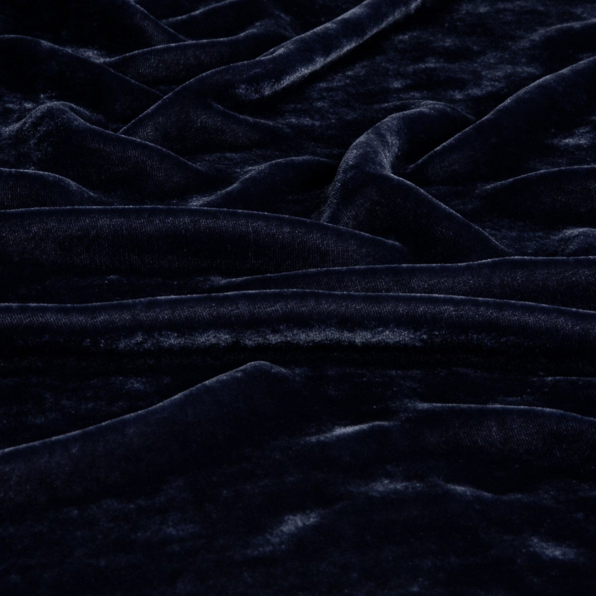 Close-up of French Lavender velvet fabric with deep folds and lustrous sheen.