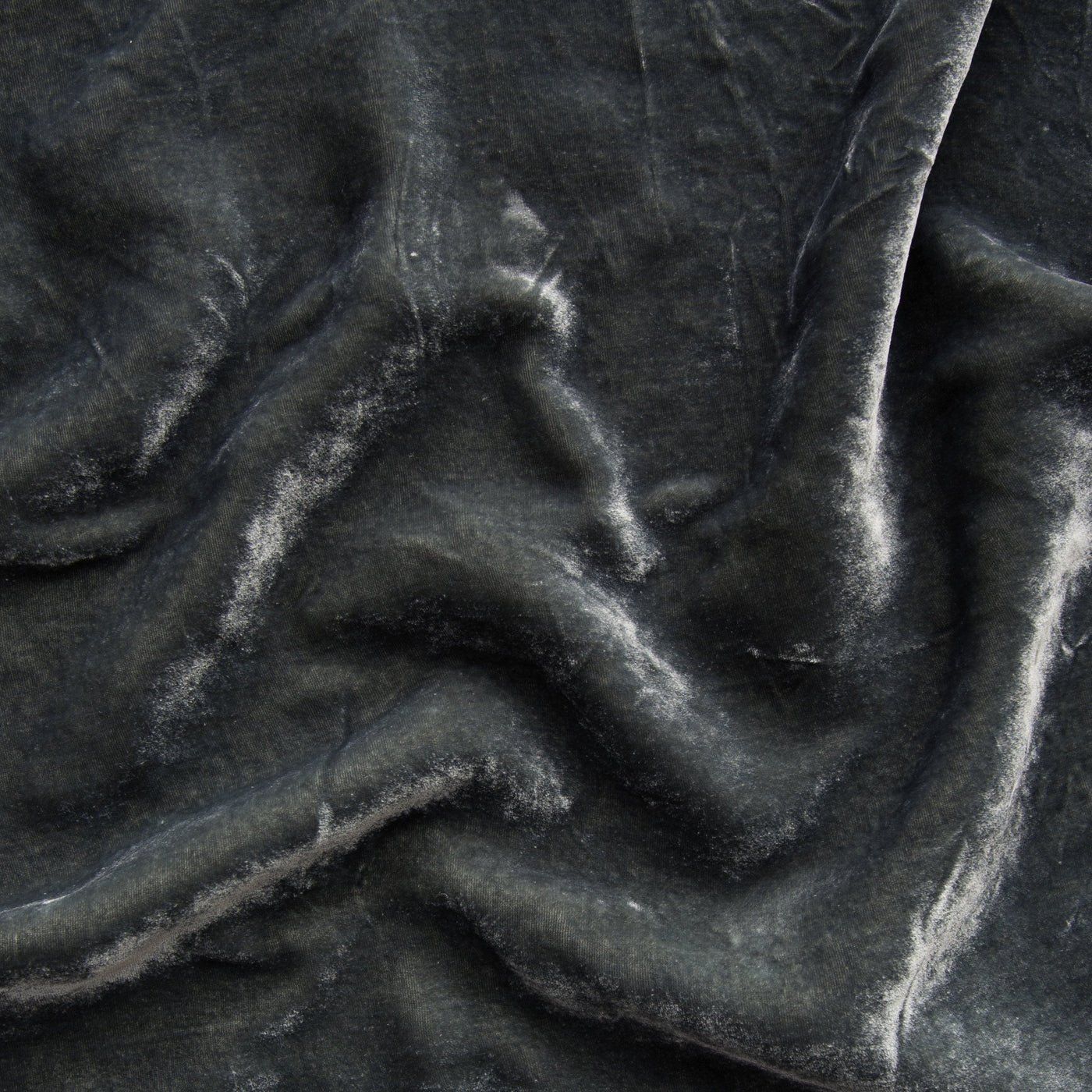 Close-up of Bella Notte Carmen throw pillow in Fog, showing draped velvet texture with soft sheen.