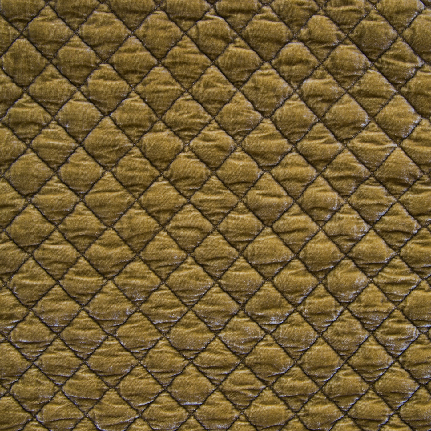 Close-up of Bella Notte Silk Velvet Quilted Blanket in Honeycomb, diamond quilting detail.