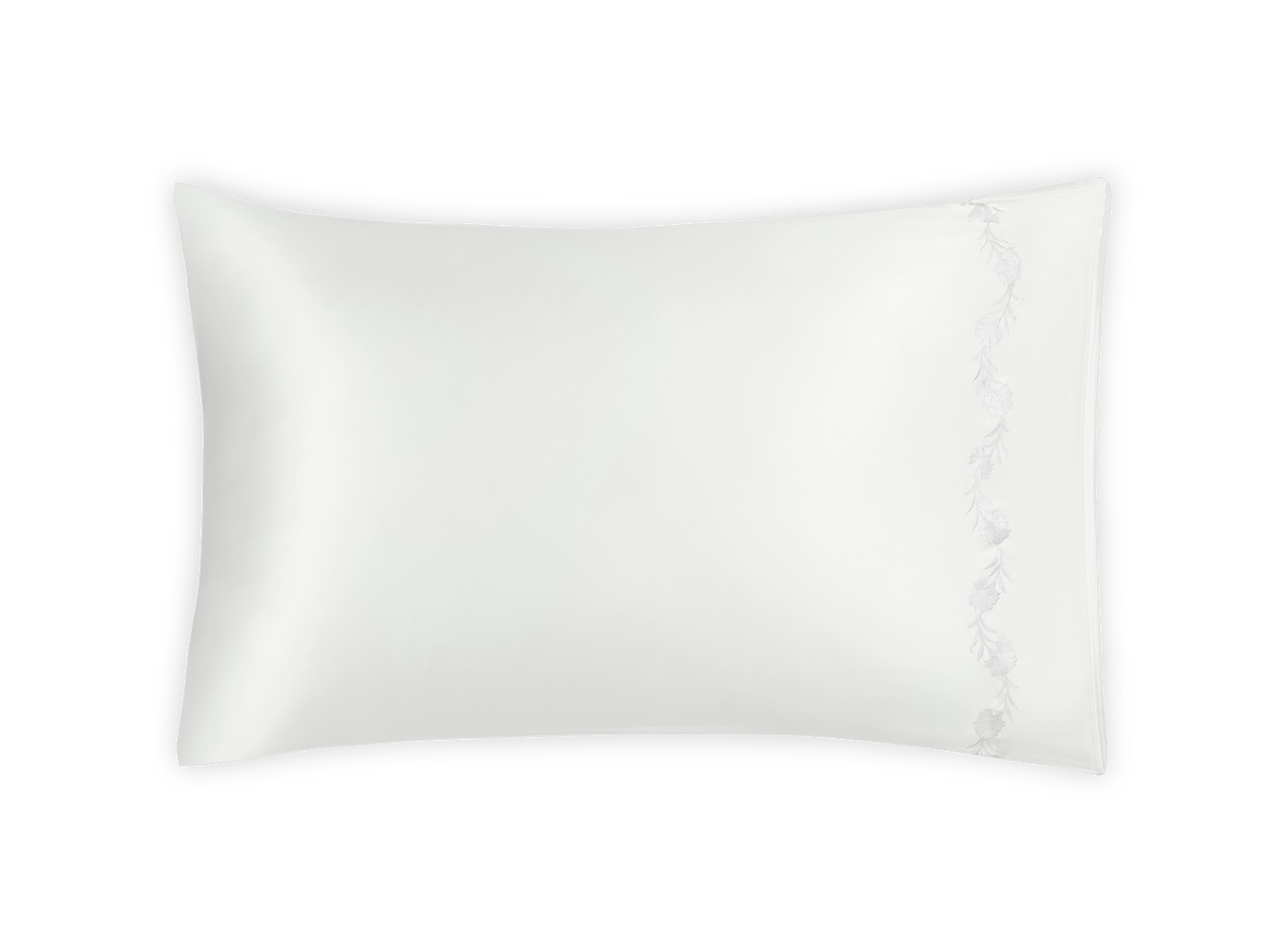 Close-up of Matouk Daphne silk pillowcase with delicate floral embroidery on white.