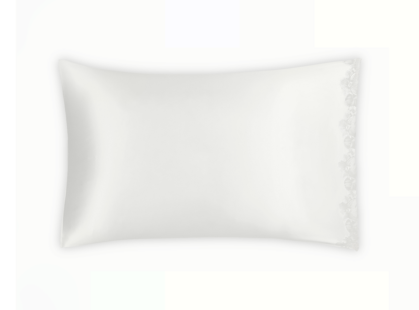 Floral embroidered edge detail on ivory silk pillowcase against white background.