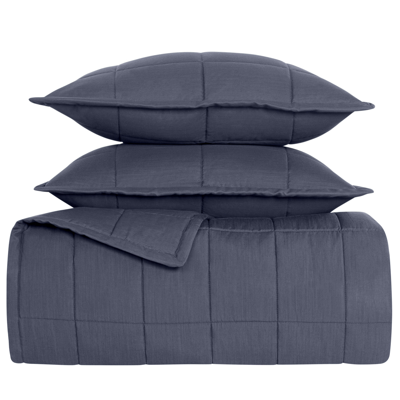 Close-up of Ann Gish Slub Tencel coverlet set in slate blue with grid-stitch quilting, stacked with two shams.
