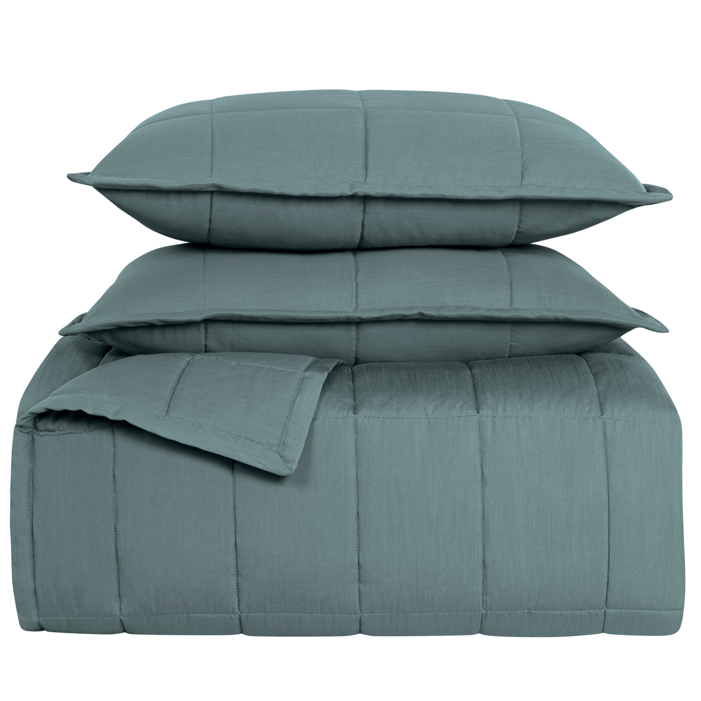 Close-up of Ann Gish Slub Tencel coverlet set stacked in slate teal with wide channel quilting.