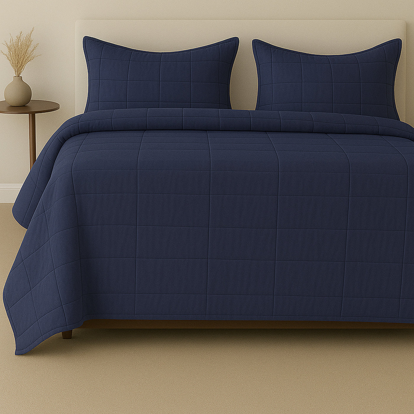 Navy Ann Gish Slub Tencel coverlet set styled on a bed with matching shams.