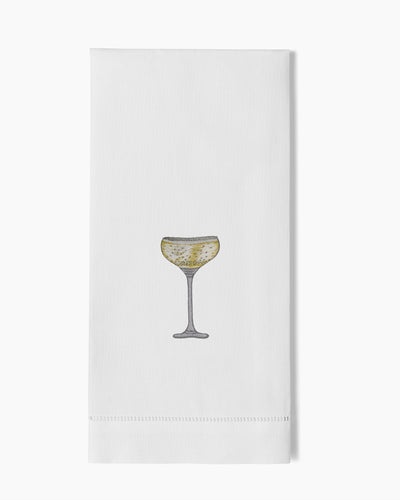 Henry Handwork white linen hand towel with embroidered champagne coupe glass in gold and grey.