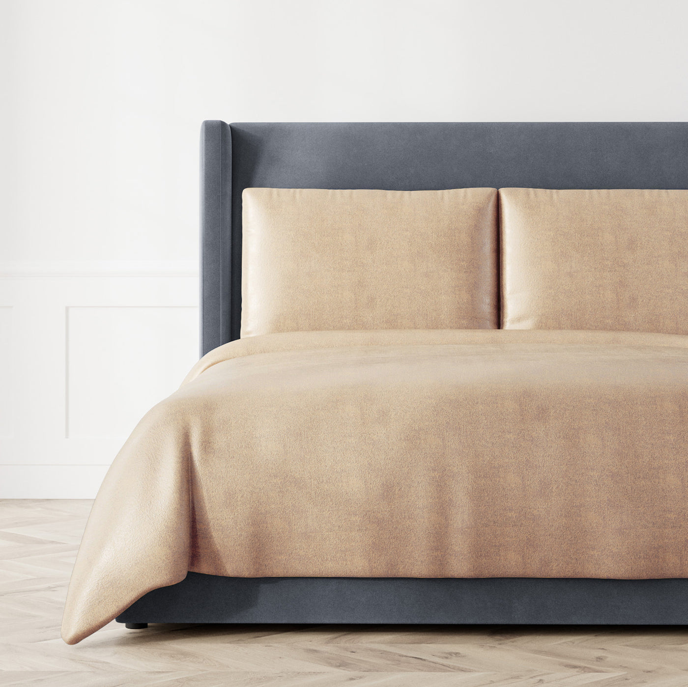 Ann Gish Stardust coverlet in champagne styled on bed with matching shams.