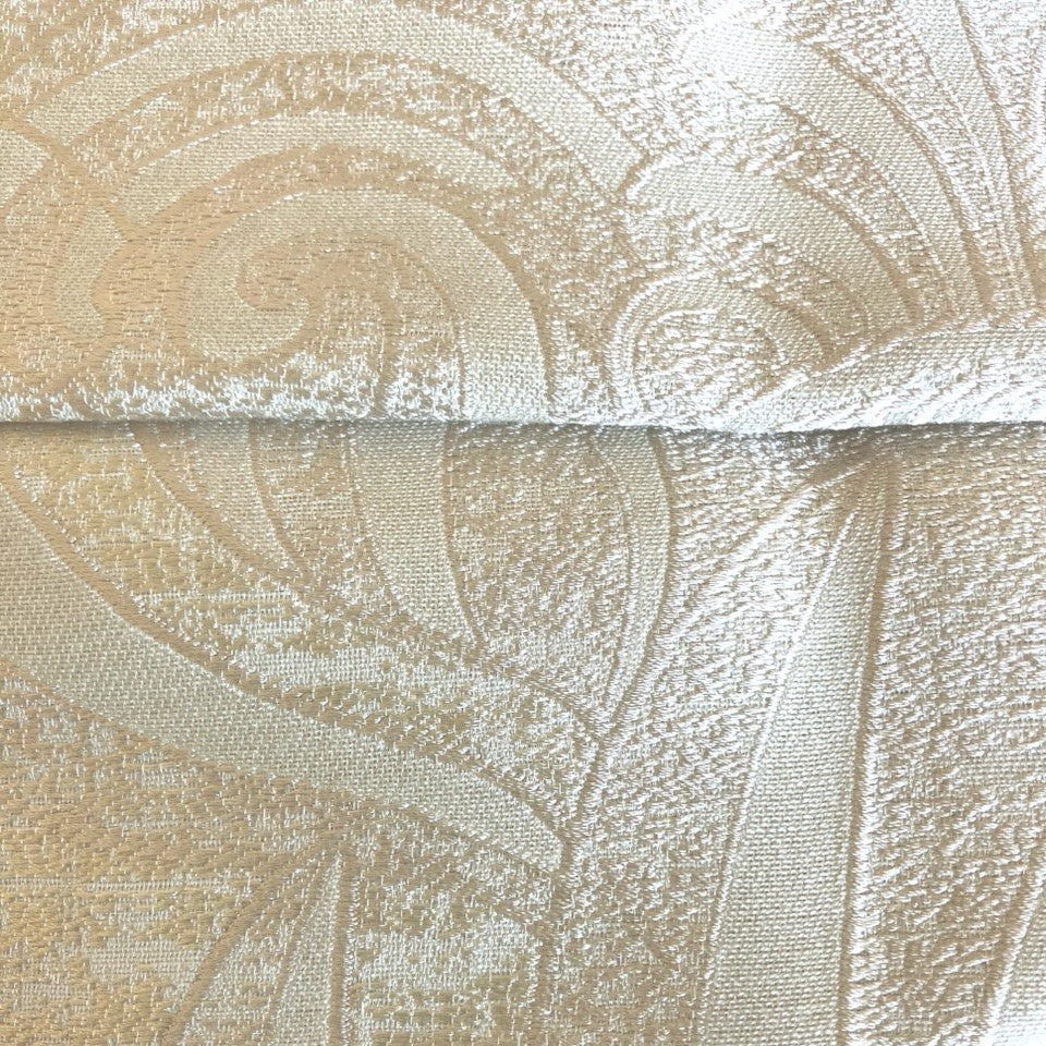 Close-up of Ann Gish Akterion duvet cover showing champagne jacquard swirl pattern and weave detail.
