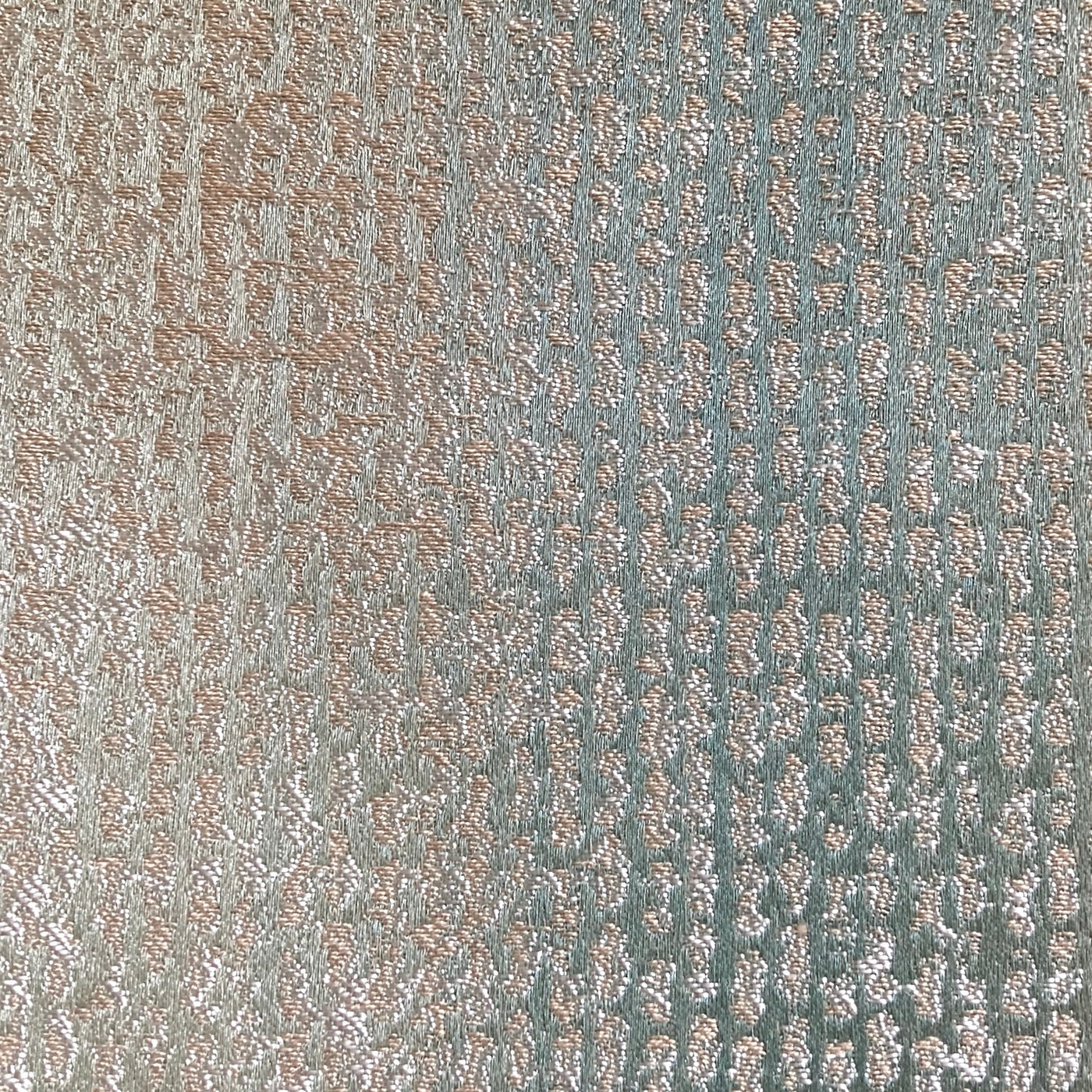 Close-up of Ann Gish Anguilla duvet cover showing shimmer weave texture in sage and rose gold.