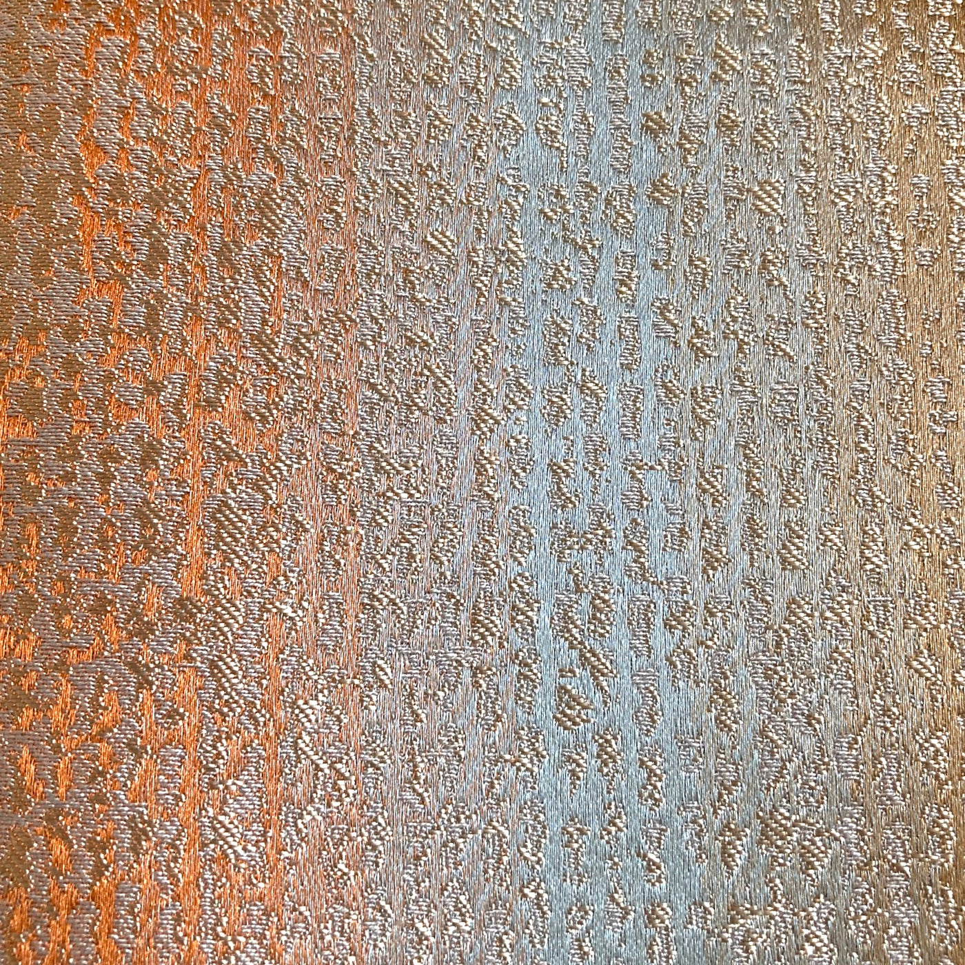 Close-up of Ann Gish Anguilla duvet cover fabric showing copper and silver textured weave.