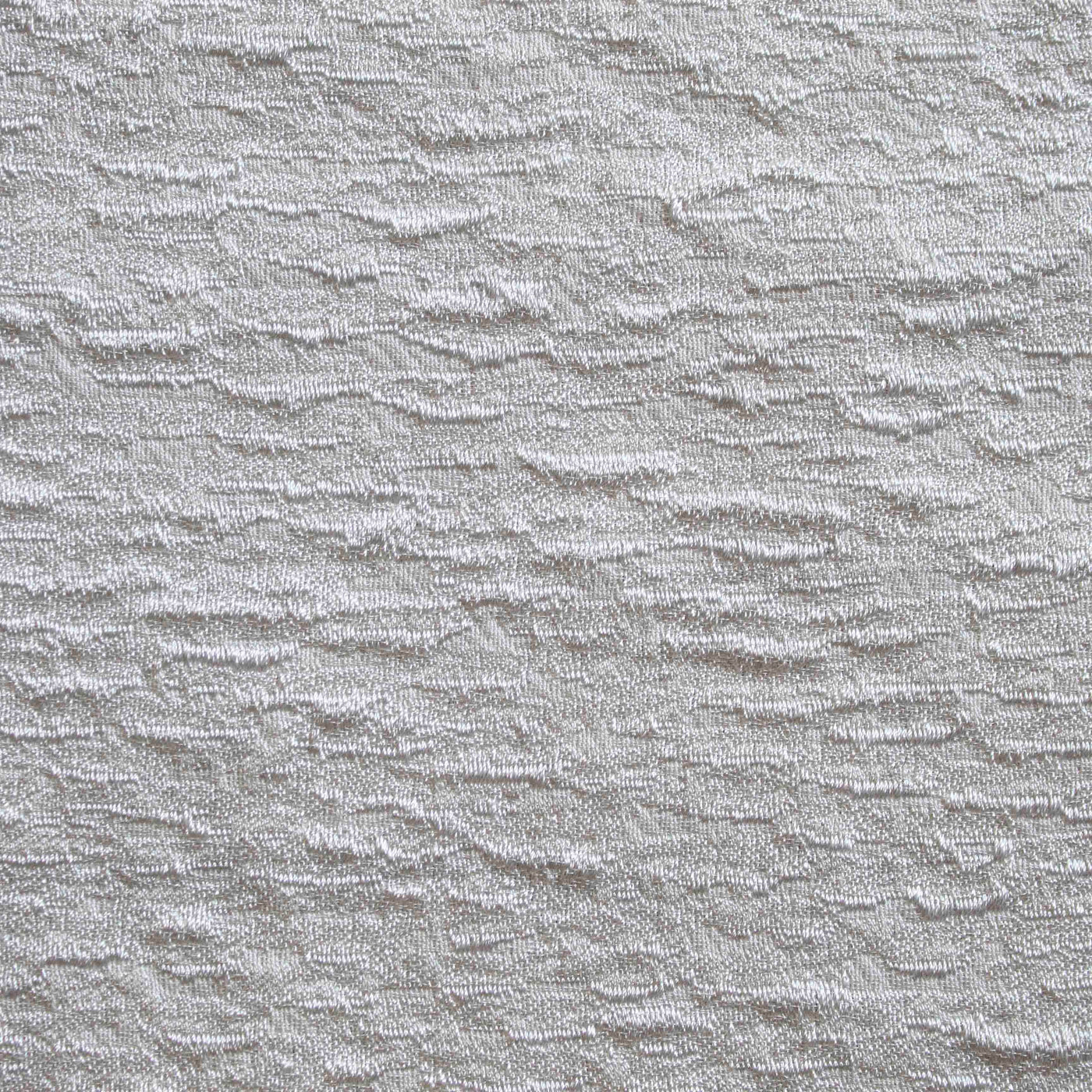 Close-up of Ann Gish Asperitas coverlet showing ivory textured wave-pattern weave detail.