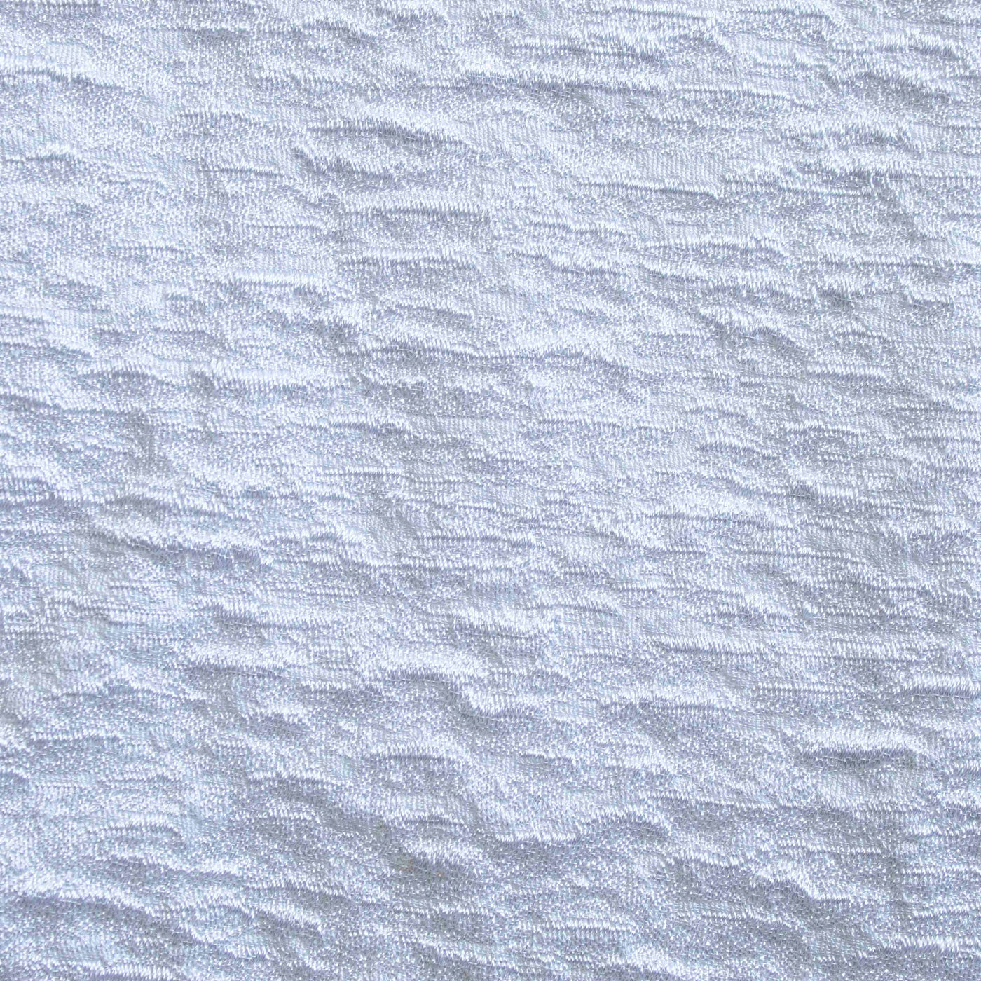 Close-up of Ann Gish Asperitas coverlet showing white textured wave-pattern weave detail.