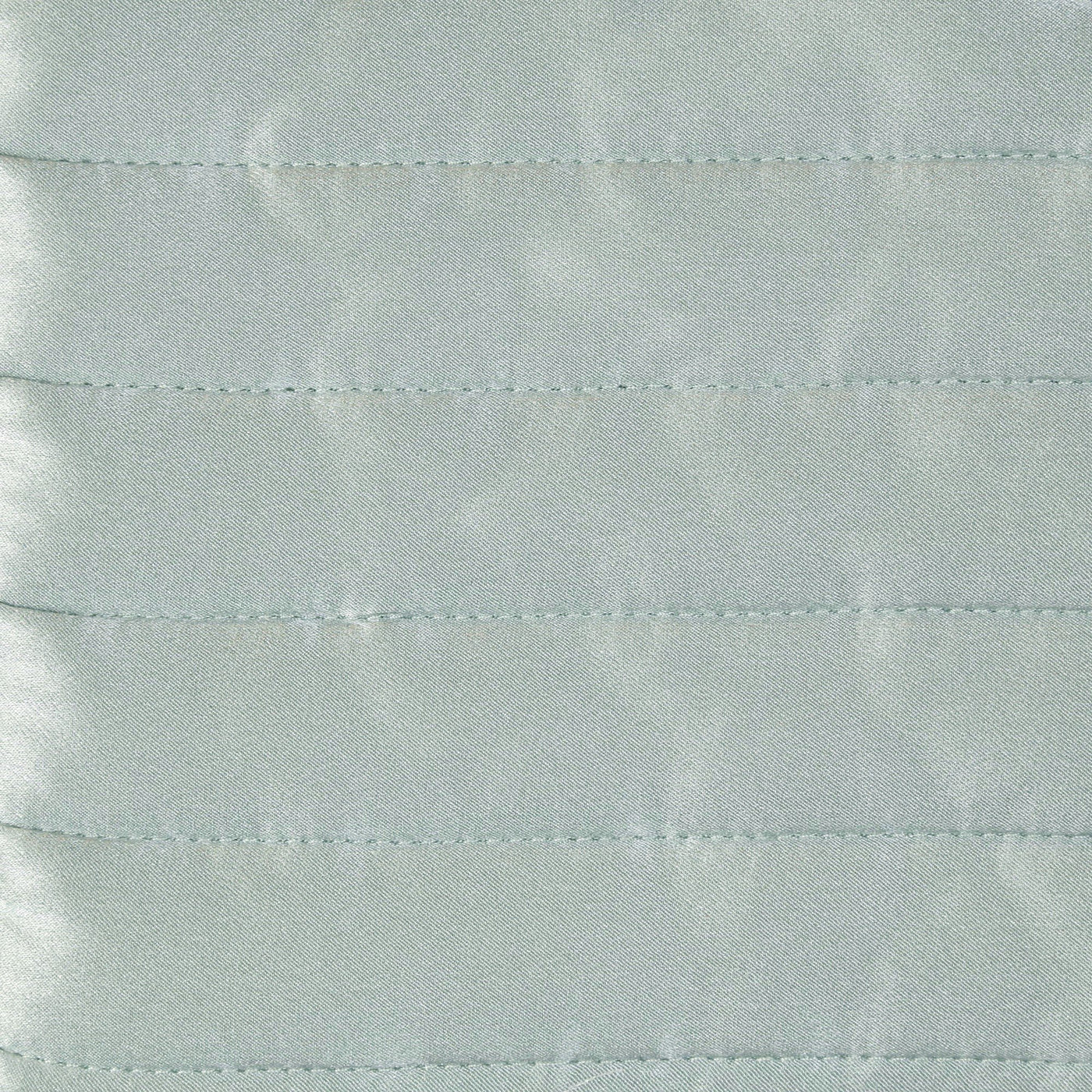 Close-up of seafoam charmeuse fabric with horizontal channel quilting stitching detail.