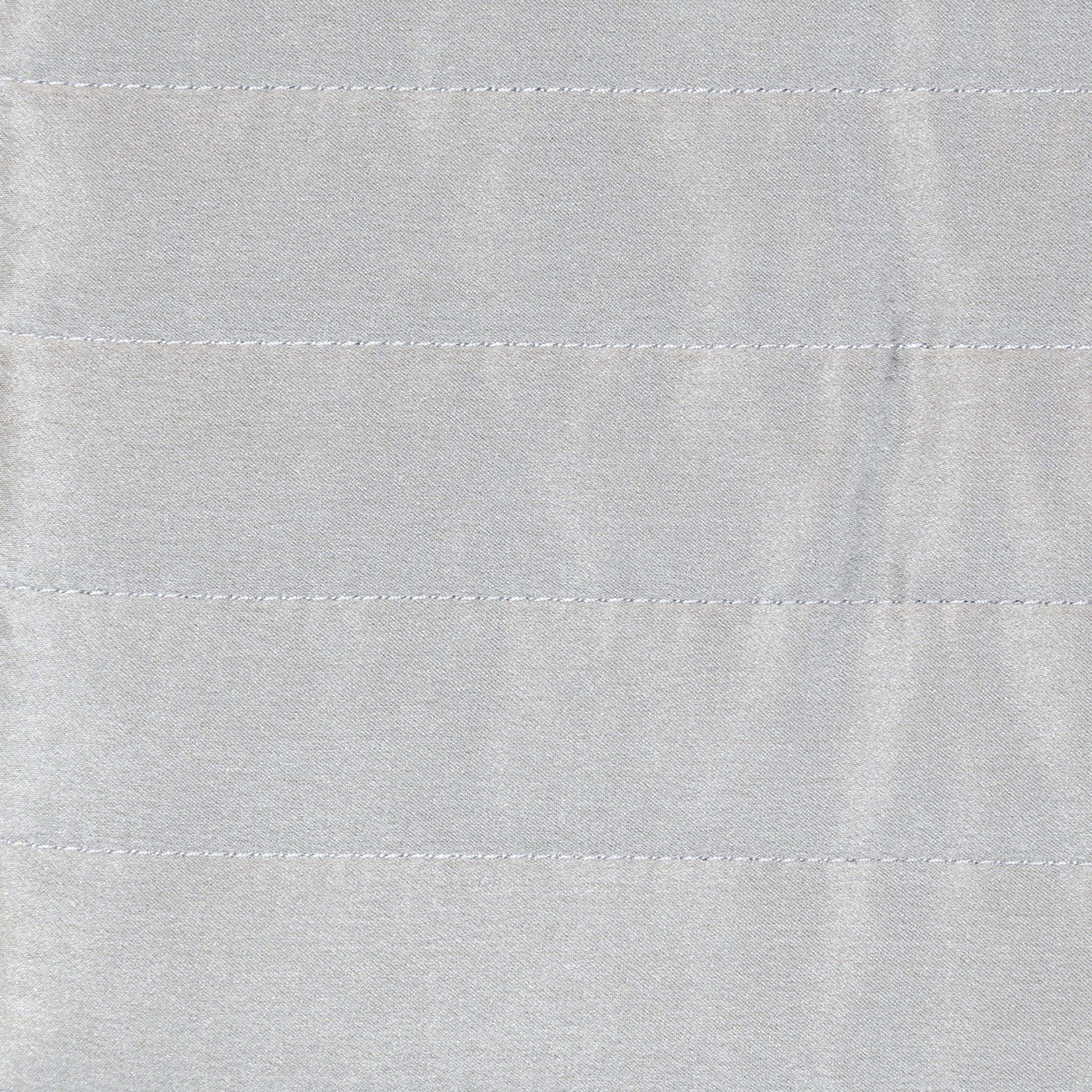 Close-up of silver charmeuse fabric with horizontal channel quilting stitches.