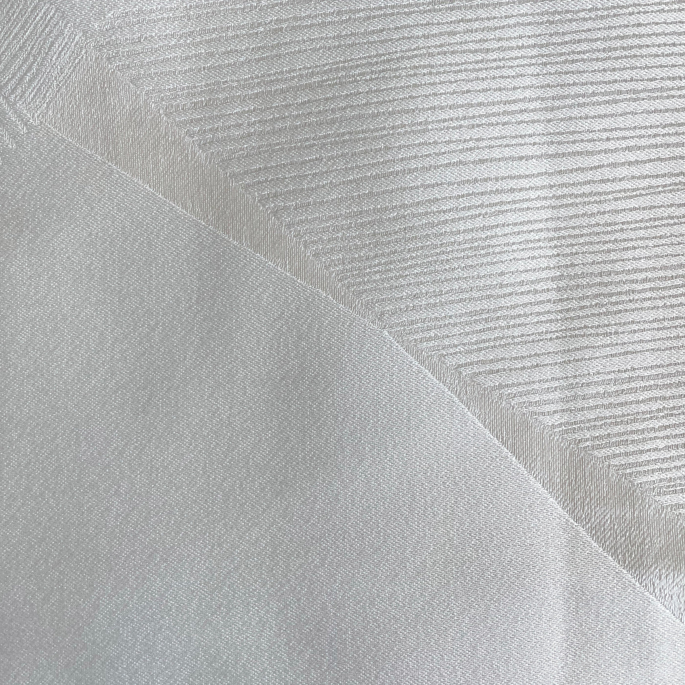 Close-up of Ann Gish Clio duvet cover in white, showing tonal stripe weave texture and fabric fold.