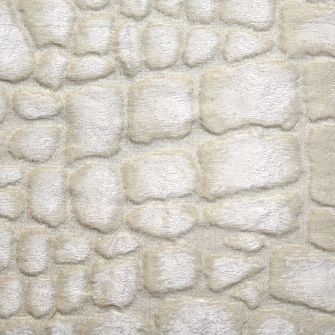 Close-up of Ann Gish Croc pillow in ivory, showing raised crocodile-textured velvet surface.
