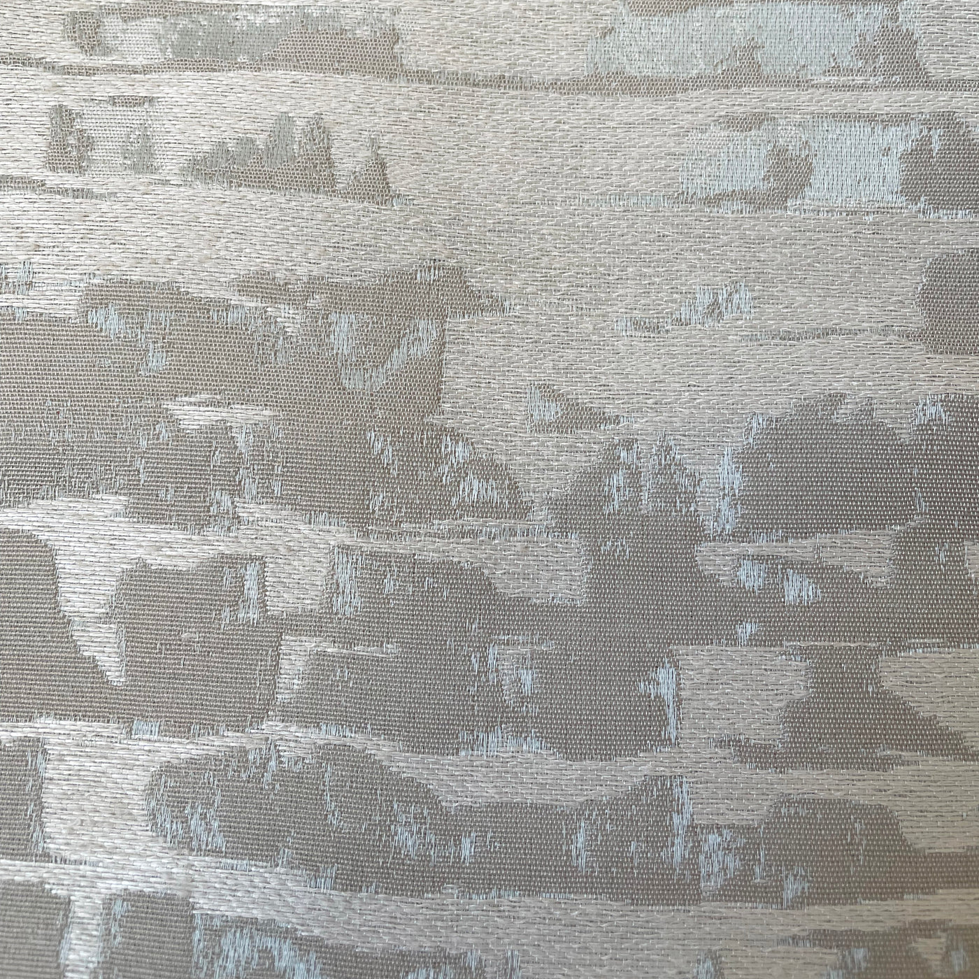 Close-up of Ann Gish Delphi duvet cover fabric, silver-grey jacquard with abstract brushstroke pattern.
