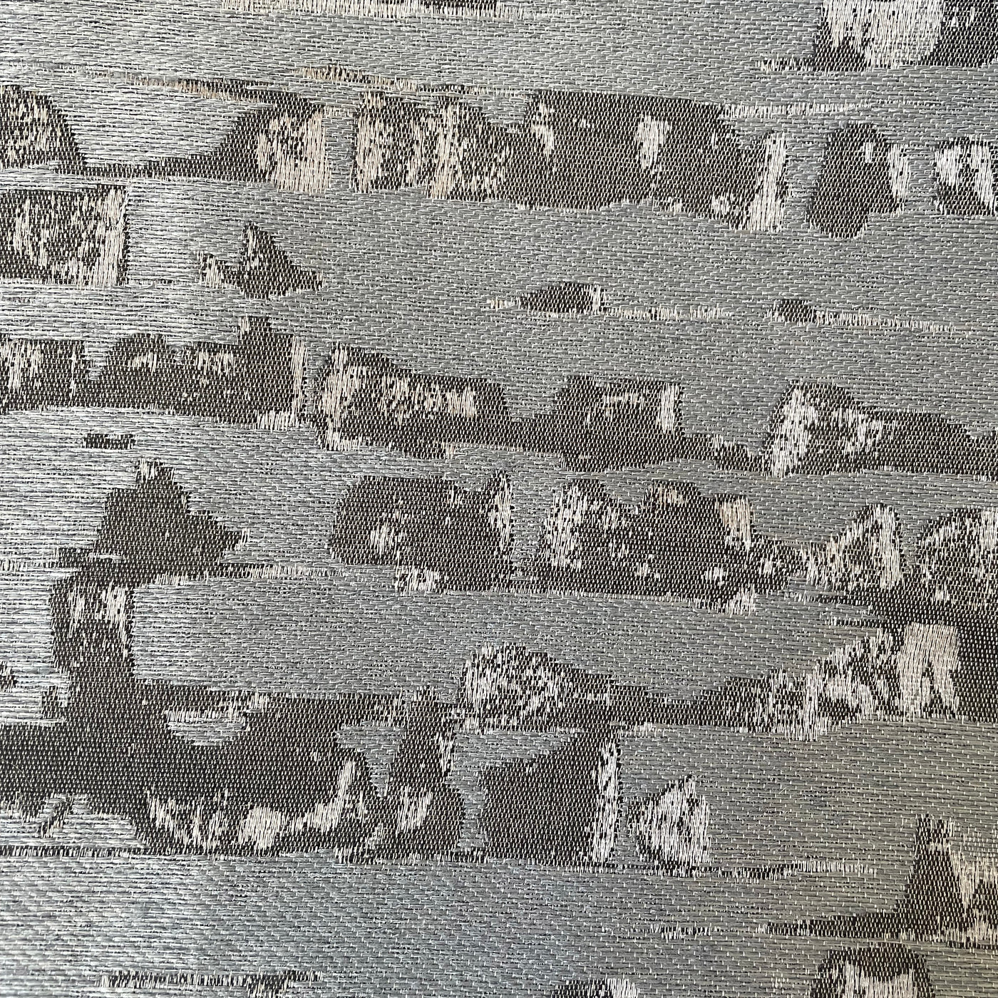 Close-up of Ann Gish Delphi duvet cover showing silver and charcoal abstract landscape weave.