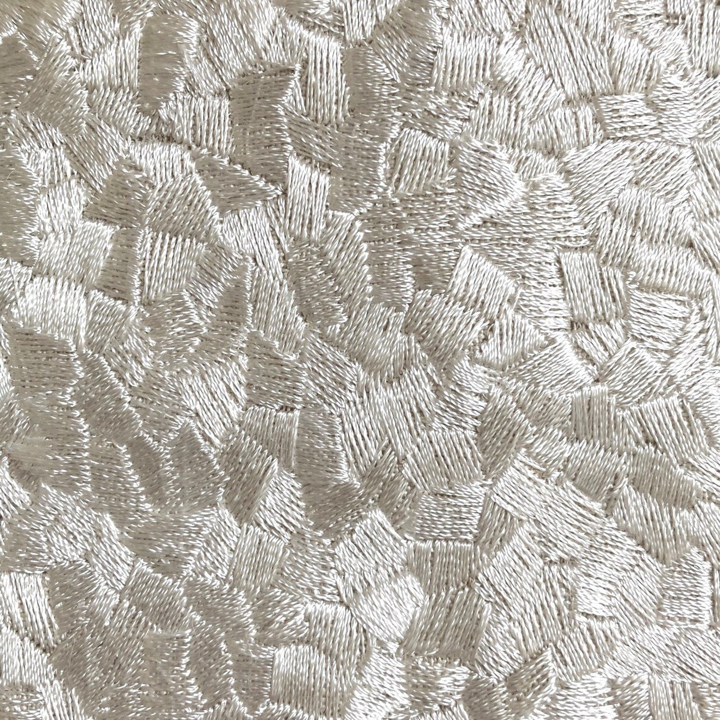 Close-up of Ann Gish Diamond Dust duvet cover showing champagne cross-hatch embroidery texture.
