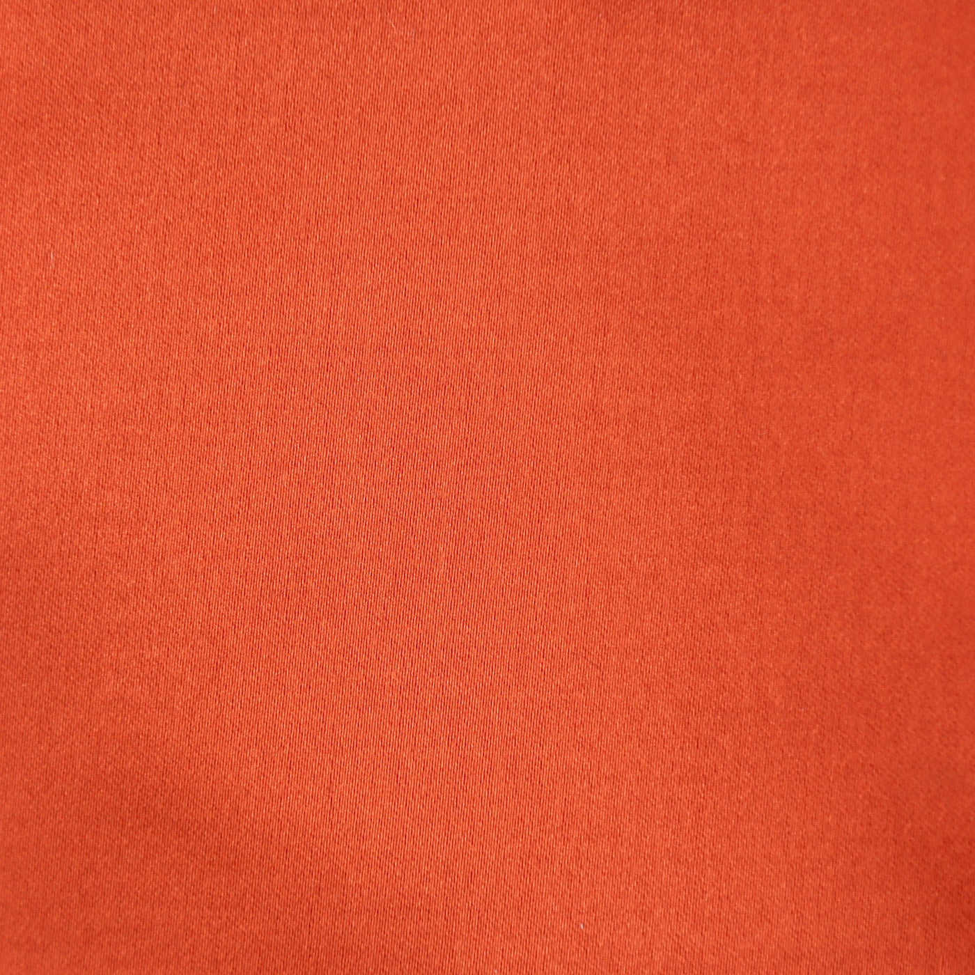 Close-up of Ann Gish Duchess pillow fabric in tangerine satin weave.