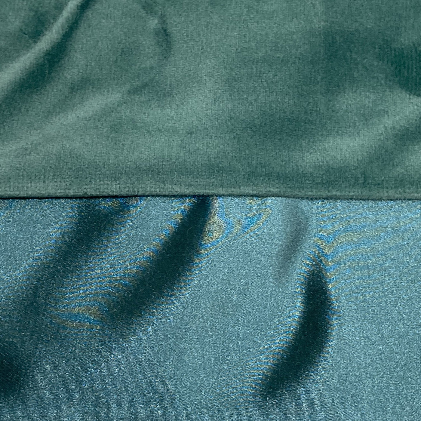 Close-up of teal velvet and shimmering satin reverse sides of Ann Gish Duchess pillow.