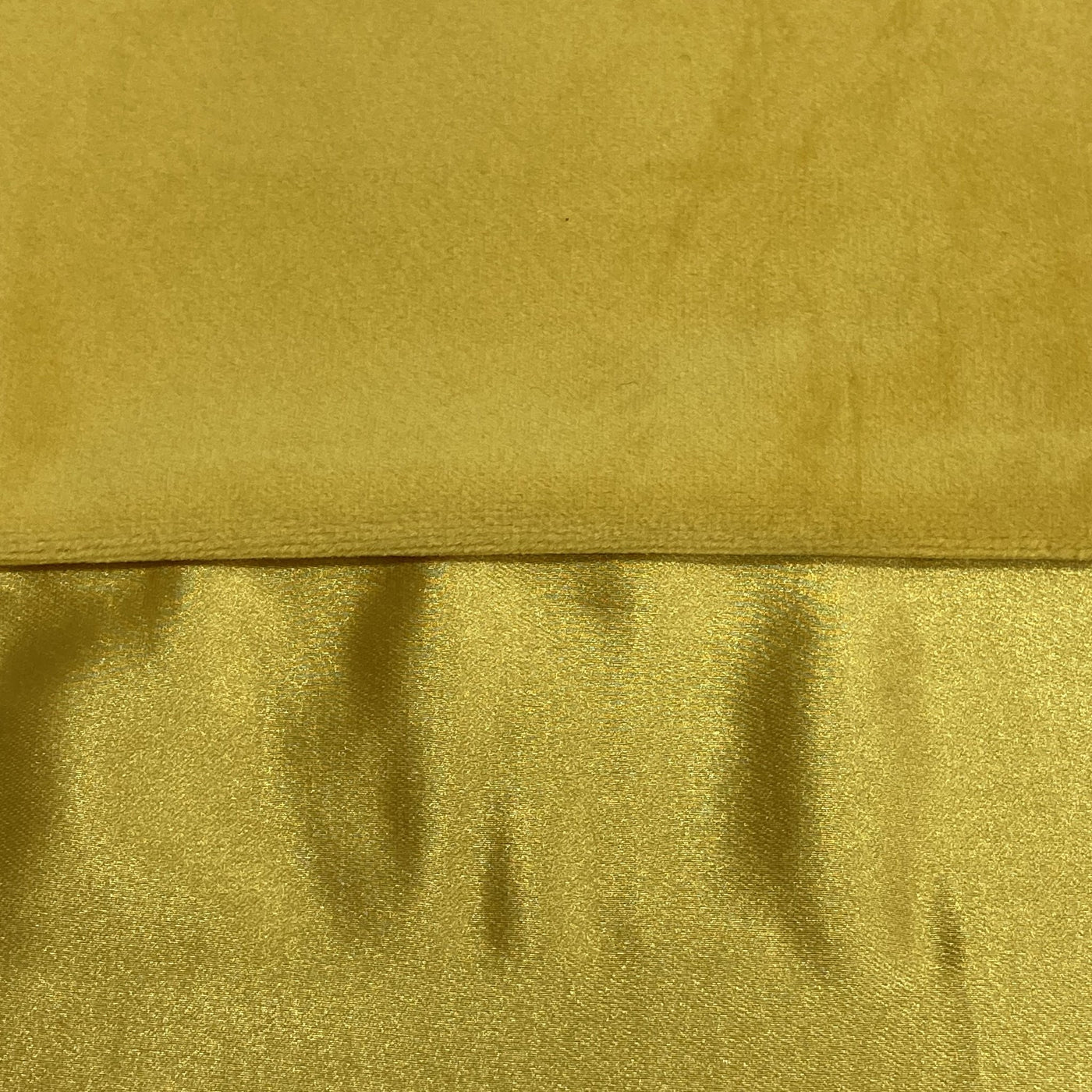 Close-up of Ann Gish Duchess pillow showing gold velvet and shimmer fabric contrast.