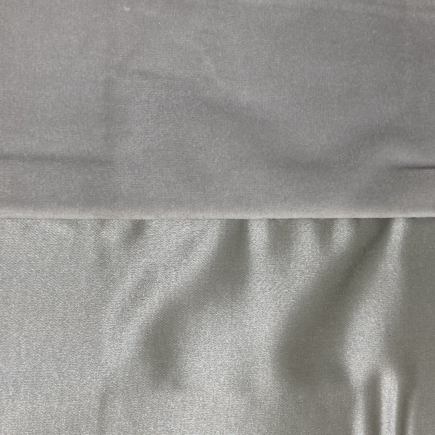 Close-up of silver duchess velvet and satin reversible fabric textures side by side.