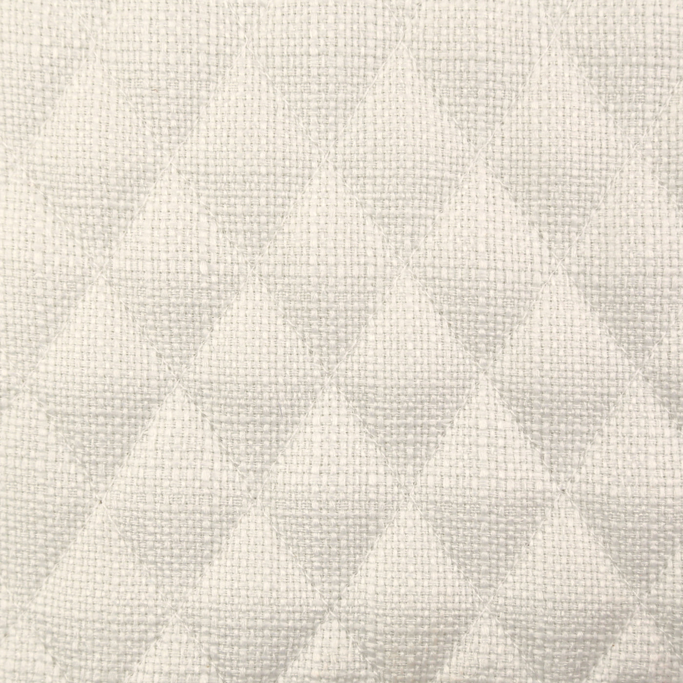 Close-up of ivory quilted diamond-pattern weave texture on Ann Gish Faux Flax coverlet.