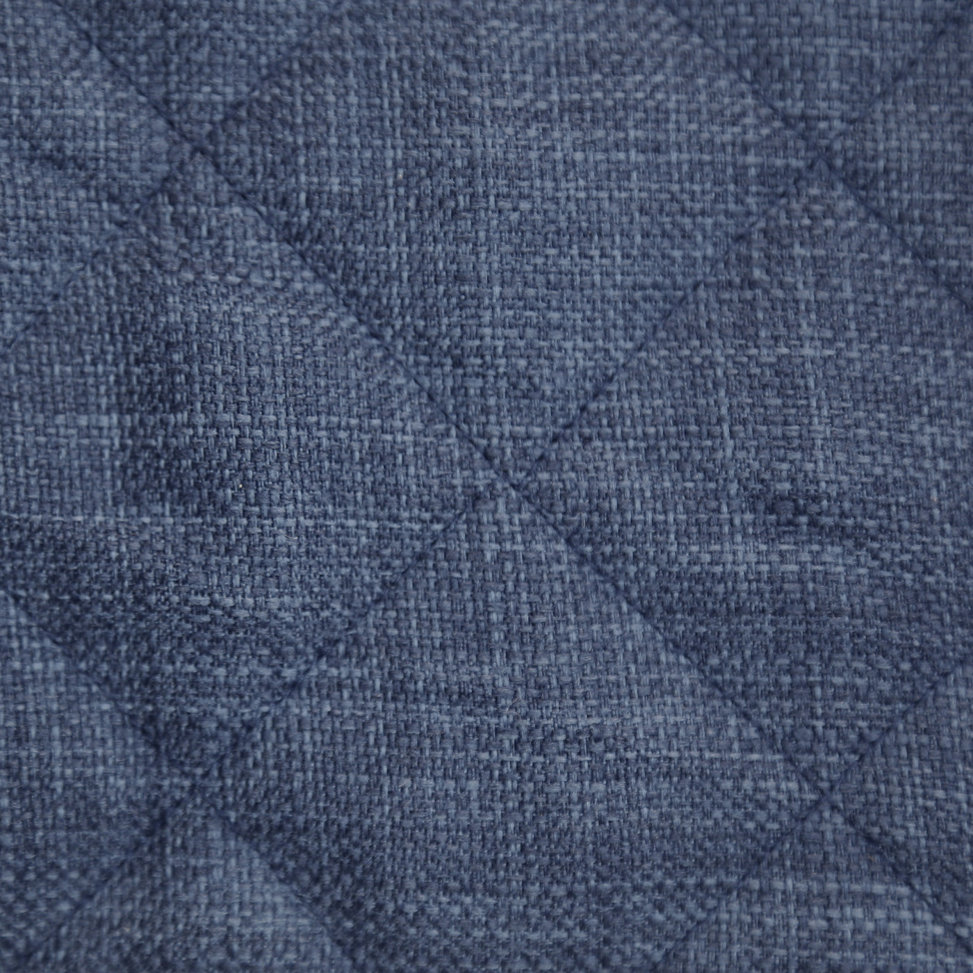 Close-up of Ann Gish Faux Linen coverlet in slate blue, showing diamond quilting and woven texture.