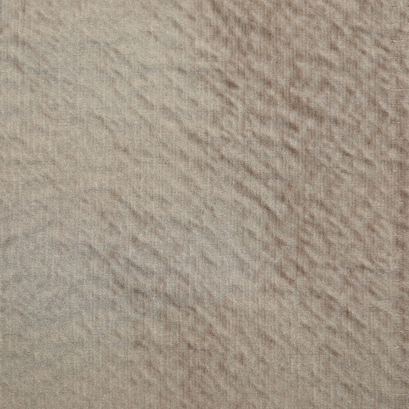 Close-up of Ann Gish Hammered box spring cover in taupe with rippled texture detail.