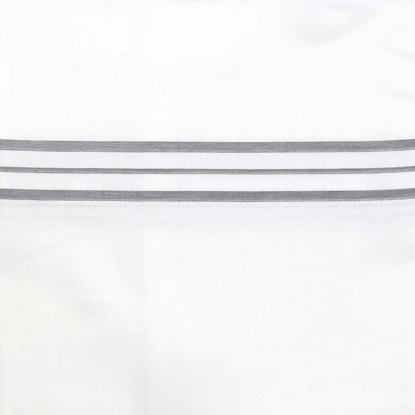 Close-up of Ann Gish Hem Stripe pillowcase showing grey triple-stripe hem detail on white cotton.