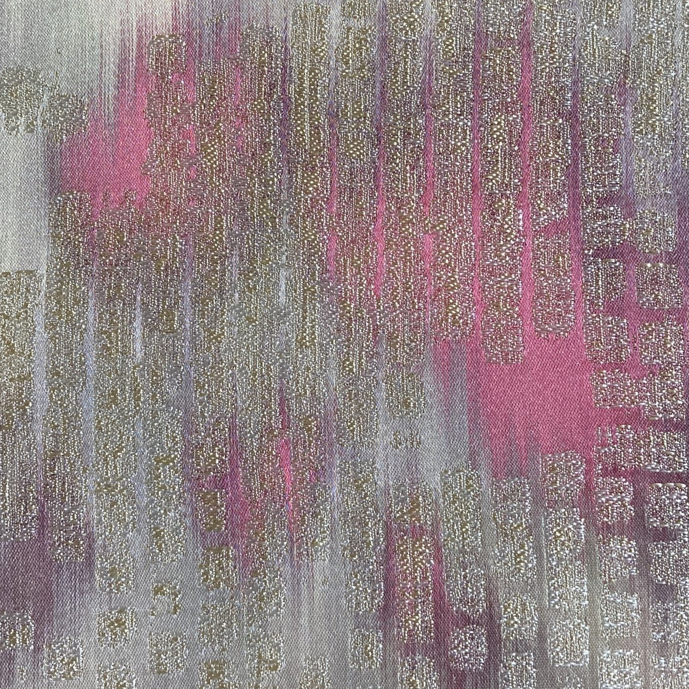 Close-up of Ann Gish Ibiza pillow fabric in rose and gold abstract brushstroke weave.