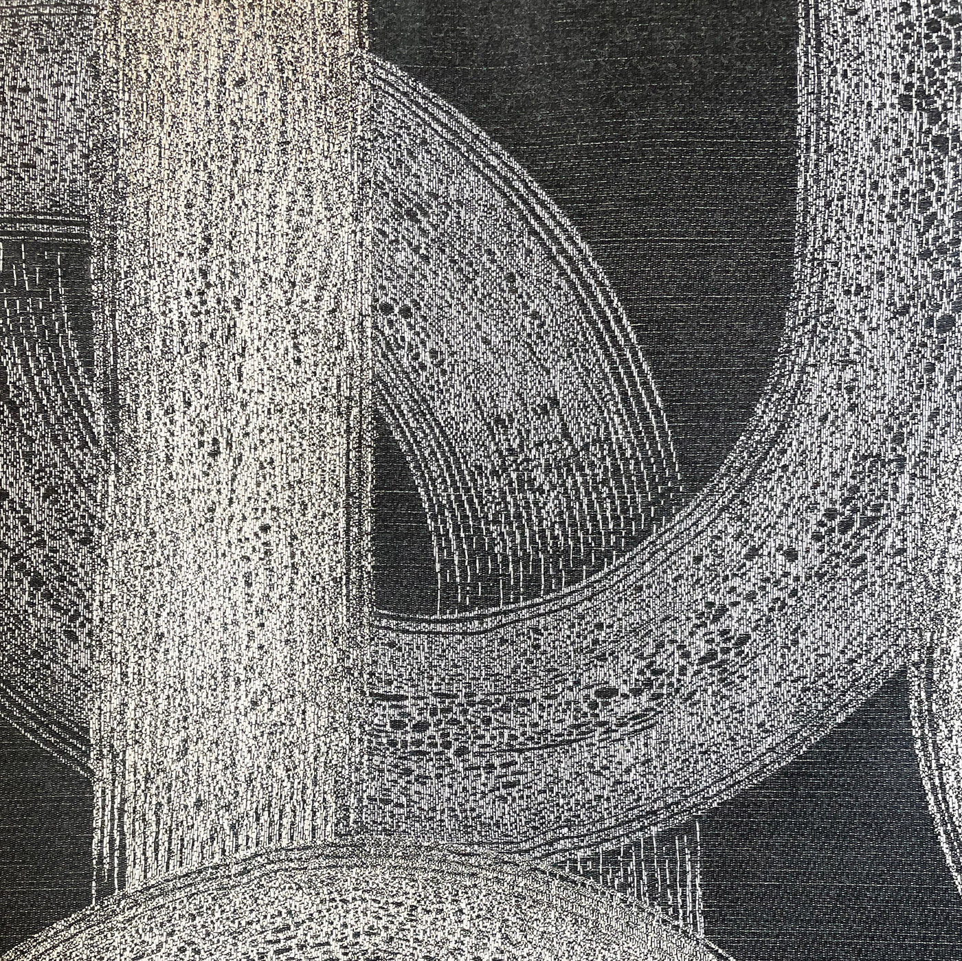 Close-up of Ann Gish Interchange duvet cover showing ivory arc pattern on charcoal linen weave.