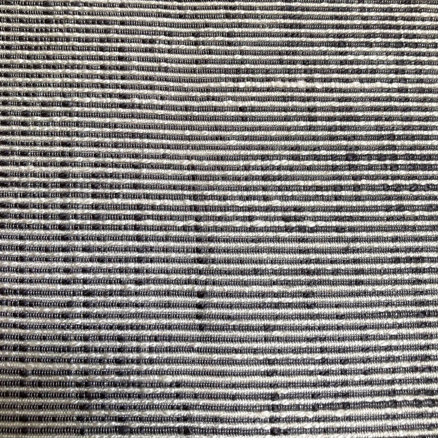 Close-up of Ann Gish Isla duvet cover woven texture in charcoal and ivory stripes.